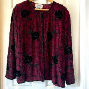 Sequined cranberry background with black dazzling beads and sequins -